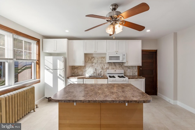 313 W 5th Ave, Conshohocken, PA 19428 - kitchen featuring white appliances, radiator heating unit, decorative backsplash, white cabinetry, and recessed lighting