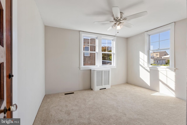 313 W 5th Ave, Conshohocken, PA 19428 - carpeted empty room with radiator heating unit, plenty of natural light, and ceiling fan