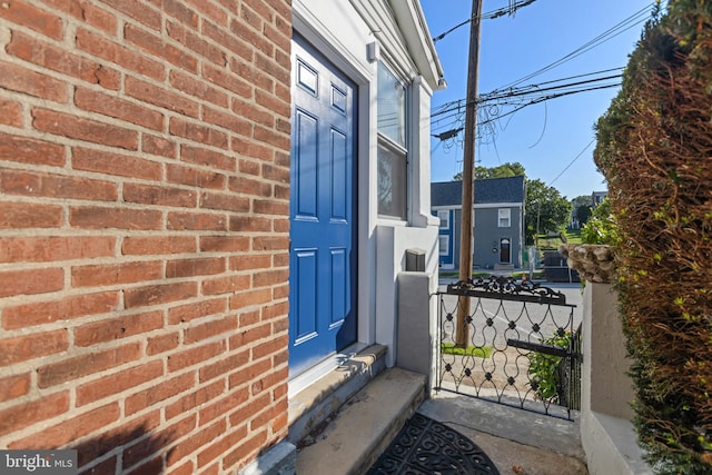 313 W 5th Ave, Conshohocken, PA 19428 - doorway to property with brick siding and a porch