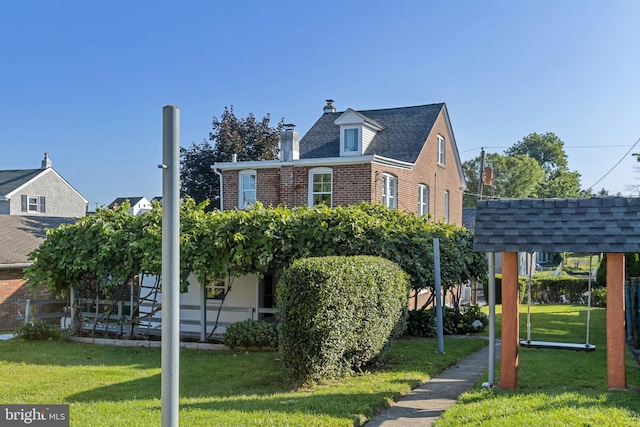 313 W 5th Ave, Conshohocken, PA 19428 - view of front of property featuring a front lawn, a chimney, and brick siding