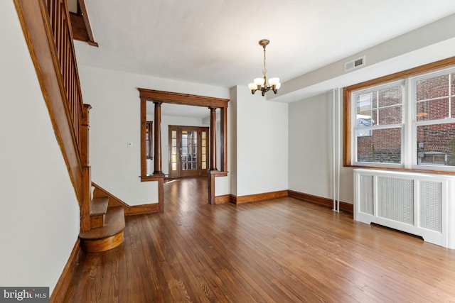 313 W 5th Ave, Conshohocken, PA 19428 - empty room with radiator, a chandelier, and hardwood / wood-style flooring