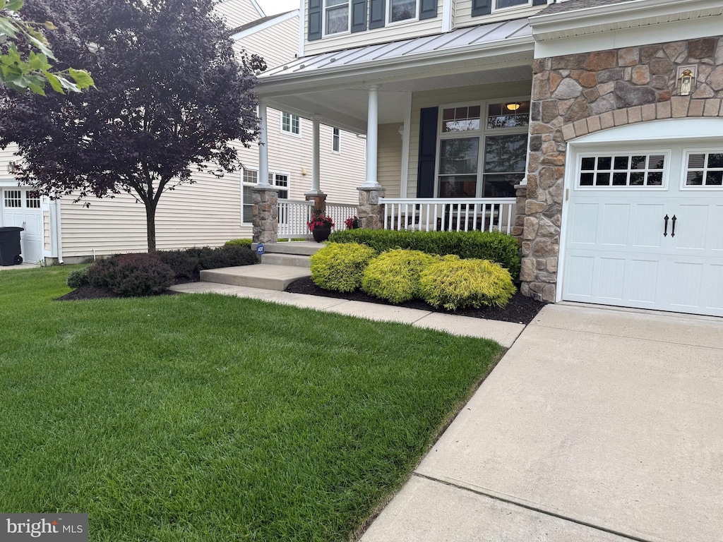 125 Starboard Way, Mount Laurel, NJ 08054 - entrance to property featuring a standing seam roof, covered porch, a lawn, a metal roof, and stone siding