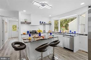 167 Kendall Blvd, Oaklyn, NJ 08107 - kitchen featuring stainless steel dishwasher, open shelves, light wood-type flooring, white cabinets, and a breakfast bar