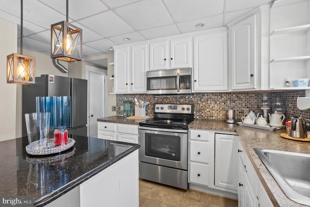 1511 Palm St, Reading, PA 19604 - kitchen featuring appliances with stainless steel finishes, open shelves, a paneled ceiling, white cabinetry, and decorative light fixtures