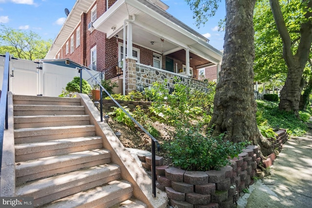 1511 Palm St, Reading, PA 19604 - view of home's exterior featuring stairway, brick siding, a chimney, and a porch