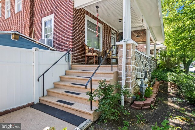 1511 Palm St, Reading, PA 19604 - doorway to property with brick siding and covered porch