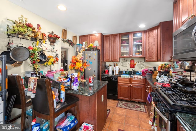 5955 Plumwood Ln, Woodbridge, VA 22193 - kitchen featuring dishwasher, stainless steel microwave, range with gas stovetop, freestanding refrigerator, and light tile patterned floors