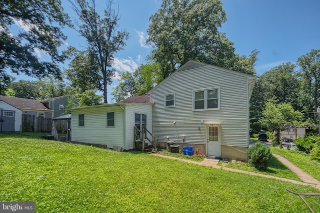 12805 Poplar St, Silver Spring, MD 20904 - rear view of property featuring a lawn, entry steps, and a shed