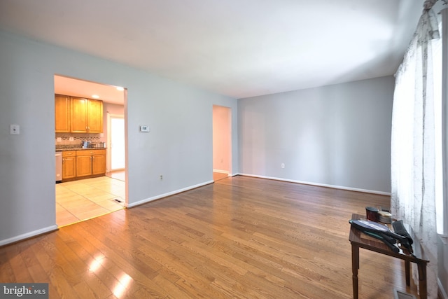 12805 Poplar St, Silver Spring, MD 20904 - unfurnished living room with light wood finished floors and baseboards