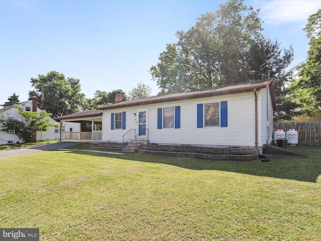 674 Harrison Ave, Berkeley Springs, WV 25411 - ranch-style home featuring asphalt driveway, a chimney, and a carport
