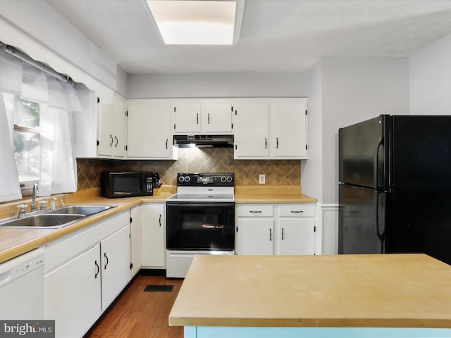 674 Harrison Ave, Berkeley Springs, WV 25411 - kitchen with black appliances, under cabinet range hood, light countertops, white cabinetry, and backsplash