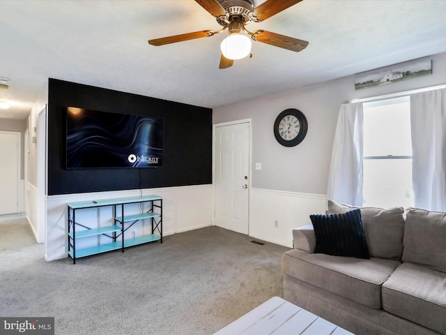 674 Harrison Ave, Berkeley Springs, WV 25411 - living room featuring carpet flooring, a ceiling fan, and wainscoting