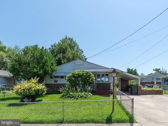 207 Canary Ln, Mount Holly, NJ 08060 - view of front of property featuring a fenced front yard, an attached carport, driveway, and brick siding