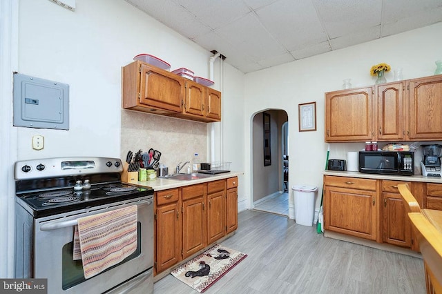 1407 Hill Rd, Reading, PA 19602 - kitchen with stainless steel electric range oven, black microwave, a drop ceiling, arched walkways, and light countertops