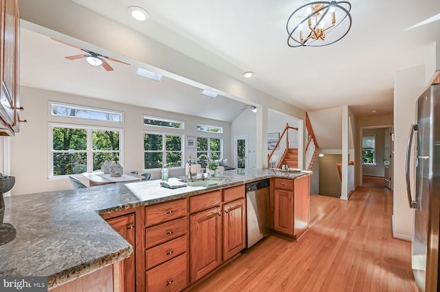 4119 Waterview Dr, Edgewater, MD 21037 - kitchen featuring stainless steel appliances, ceiling fan, vaulted ceiling, brown cabinetry, and light wood-style flooring