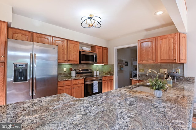 4119 Waterview Dr, Edgewater, MD 21037 - kitchen with stainless steel appliances, dark stone counters, backsplash, a chandelier, and recessed lighting