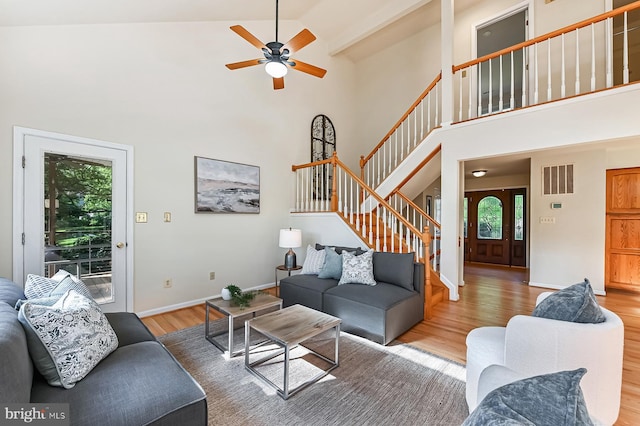 4119 Waterview Dr, Edgewater, MD 21037 - living room with wood finished floors, high vaulted ceiling, stairs, and ceiling fan