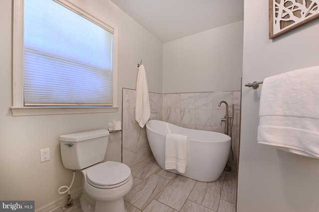4119 Waterview Dr, Edgewater, MD 21037 - bathroom featuring a freestanding tub, tile walls, and marble finish flooring