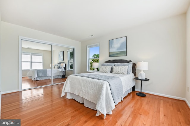 4119 Waterview Dr, Edgewater, MD 21037 - bedroom featuring multiple windows, light wood-type flooring, and a closet