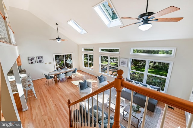 4119 Waterview Dr, Edgewater, MD 21037 - living area featuring a skylight, healthy amount of natural light, ceiling fan, high vaulted ceiling, and light wood-style flooring