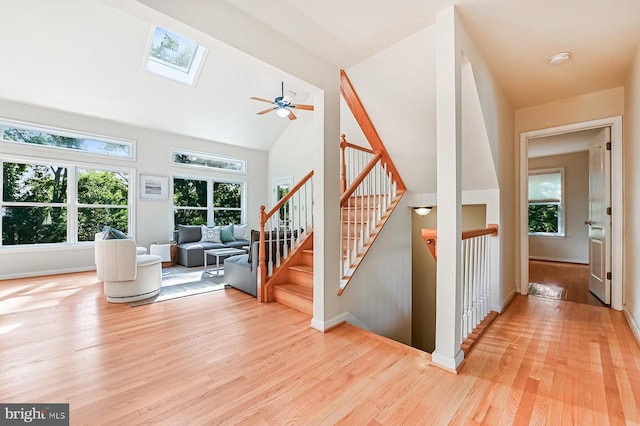 4119 Waterview Dr, Edgewater, MD 21037 - stairway with plenty of natural light, a skylight, wood finished floors, and high vaulted ceiling