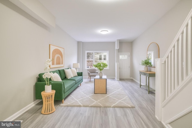 429 N Lakewood Ave, Baltimore, MD 21224 - living room with light wood finished floors and stairway