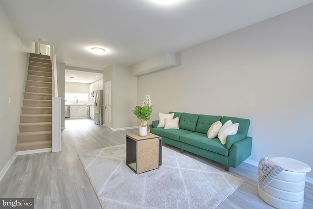 429 N Lakewood Ave, Baltimore, MD 21224 - living room with light wood-style flooring and stairway