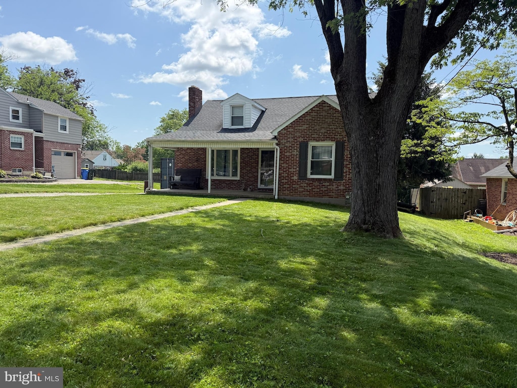404 Corbin Rd, York, PA 17403 - view of front of property with brick siding, a chimney, and an attached garage