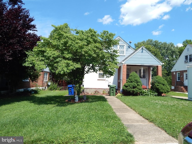5809 Eurith Ave, Baltimore, MD 21206 - view of front facade featuring a front yard and brick siding