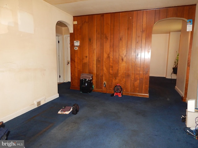 5809 Eurith Ave, Baltimore, MD 21206 - unfurnished room with arched walkways, wooden walls, and carpet flooring
