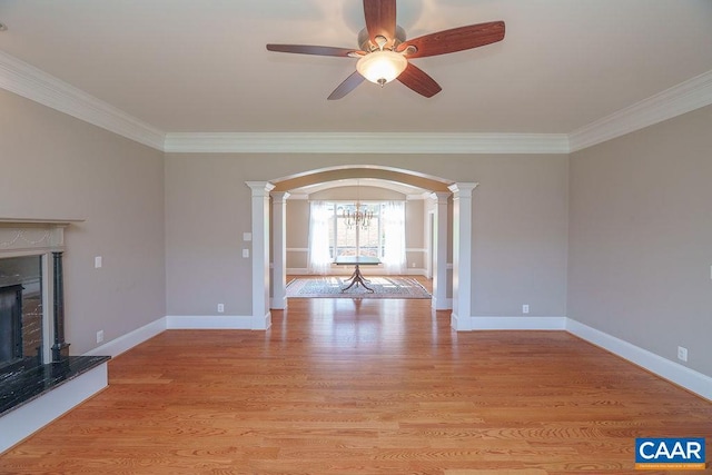3525 Rocks Mill Ln, Charlottesville, VA 22903 - unfurnished living room featuring arched walkways, crown molding, a high end fireplace, a ceiling fan, and ornate columns