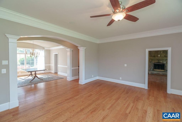 3525 Rocks Mill Ln, Charlottesville, VA 22903 - spare room with arched walkways, ornate columns, a chandelier, crown molding, and light wood finished floors
