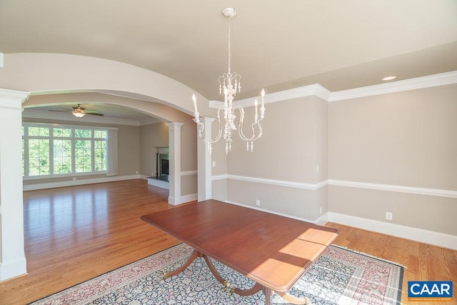 3525 Rocks Mill Ln, Charlottesville, VA 22903 - unfurnished dining area featuring arched walkways, ornate columns, ceiling fan, wood finished floors, and crown molding