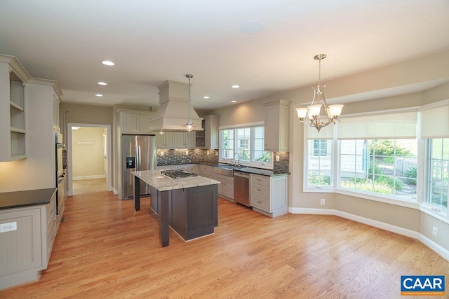 3525 Rocks Mill Ln, Charlottesville, VA 22903 - kitchen featuring appliances with stainless steel finishes, premium range hood, decorative backsplash, light wood-type flooring, and a center island