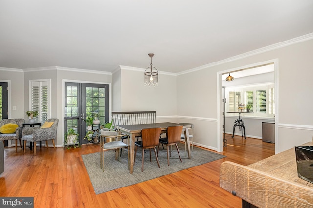 9016 Greylock St, Alexandria, VA 22308 - dining space featuring wood finished floors, healthy amount of natural light, french doors, and crown molding