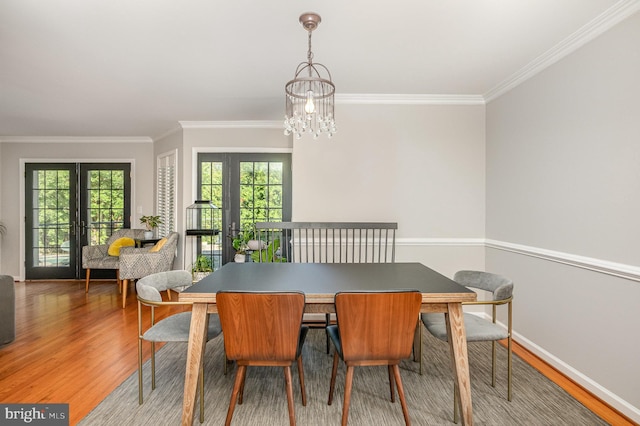 9016 Greylock St, Alexandria, VA 22308 - dining room with wood finished floors, ornamental molding, a chandelier, and french doors