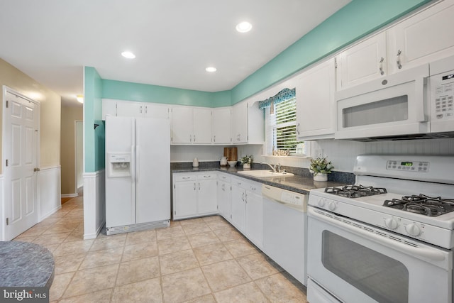 510 Revere Ct, Hockessin, DE 19707 - kitchen with white appliances, dark countertops, white cabinetry, and recessed lighting