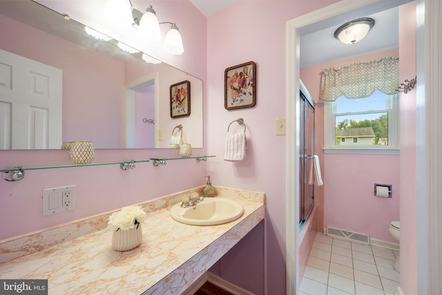 510 Revere Ct, Hockessin, DE 19707 - bathroom with vanity, tile patterned floors, and bath / shower combo with glass door