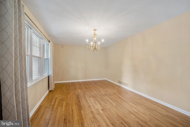 510 Revere Ct, Hockessin, DE 19707 - empty room featuring light wood-type flooring and a chandelier