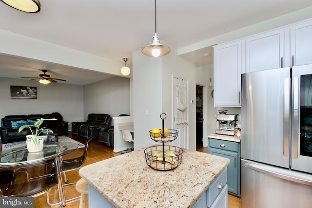 14813 Blackburn Rd, Burtonsville, MD 20866 - kitchen featuring freestanding refrigerator, blue cabinets, ceiling fan, light wood finished floors, and open floor plan