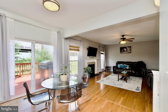 14813 Blackburn Rd, Burtonsville, MD 20866 - dining area featuring ceiling fan, a tiled fireplace, and wood finished floors