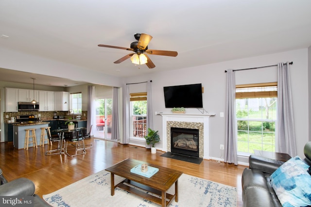 14813 Blackburn Rd, Burtonsville, MD 20866 - living area featuring a ceiling fan, wood finished floors, and a tiled fireplace