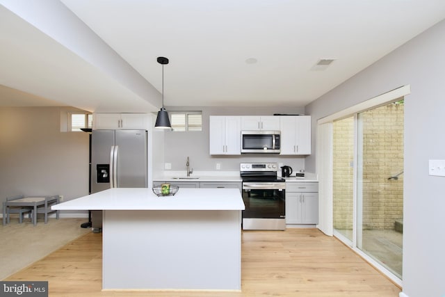 14813 Blackburn Rd, Burtonsville, MD 20866 - kitchen with appliances with stainless steel finishes, light countertops, white cabinetry, and a kitchen island