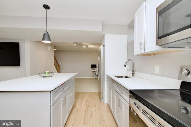 14813 Blackburn Rd, Burtonsville, MD 20866 - kitchen featuring stainless steel appliances, light wood-style flooring, white cabinetry, pendant lighting, and a center island