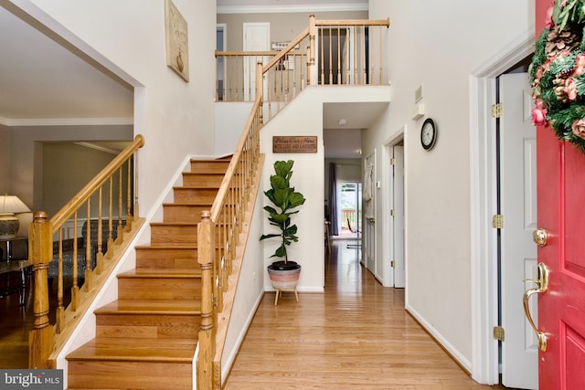 14813 Blackburn Rd, Burtonsville, MD 20866 - entryway with stairs, light wood-type flooring, crown molding, and a high ceiling