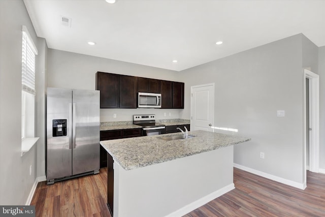 2 American Ave, Carlisle, PA 17013 - kitchen featuring stainless steel appliances, wood finished floors, dark brown cabinets, an island with sink, and light stone countertops