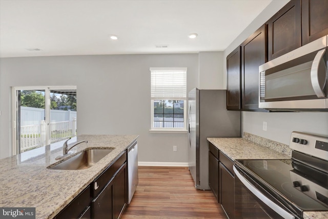 2 American Ave, Carlisle, PA 17013 - kitchen featuring appliances with stainless steel finishes, healthy amount of natural light, light wood finished floors, dark brown cabinetry, and recessed lighting