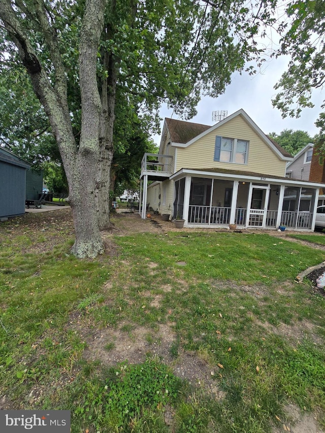 214 Dennison St, Colonial Beach, VA 22443 - back of property with a sunroom and a lawn