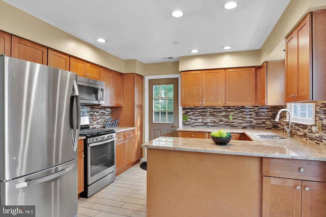 26 Millbank Ln, Voorhees, NJ 08043 - kitchen featuring stainless steel appliances, a peninsula, light stone countertops, decorative backsplash, and recessed lighting