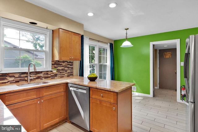 26 Millbank Ln, Voorhees, NJ 08043 - kitchen with stainless steel appliances, a peninsula, tasteful backsplash, brown cabinetry, and recessed lighting